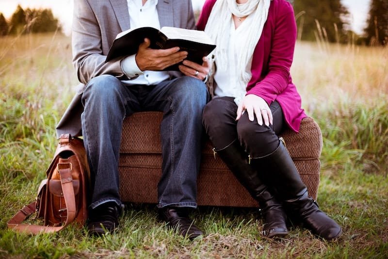 a man and woman reading bible